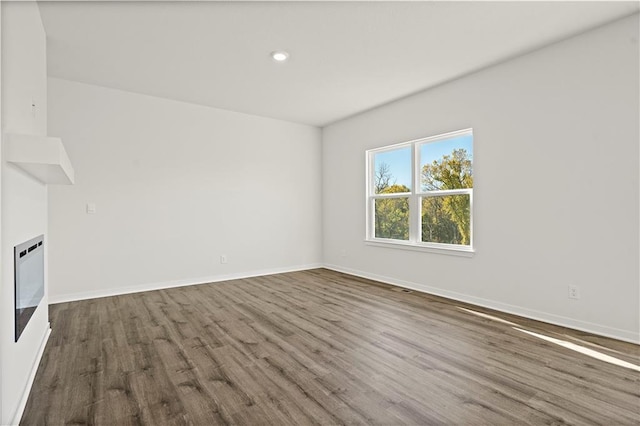 unfurnished living room featuring dark hardwood / wood-style floors