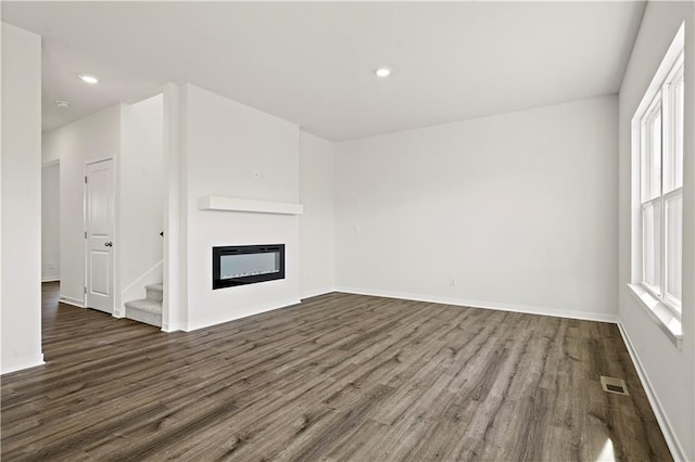 unfurnished living room with dark hardwood / wood-style flooring