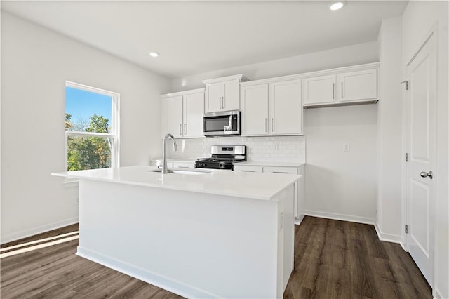 kitchen with white cabinetry, a center island with sink, stainless steel appliances, and sink