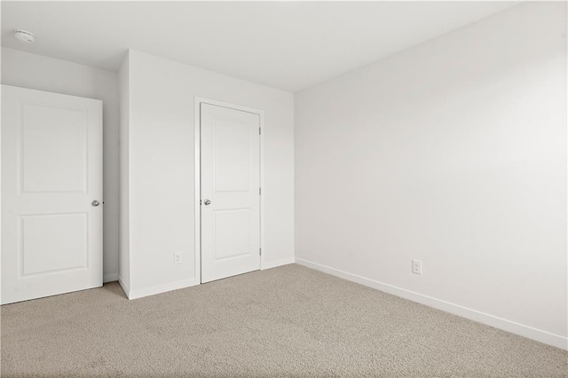 unfurnished bedroom featuring carpet flooring and a closet