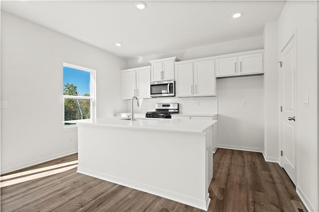 kitchen with a center island with sink, white cabinetry, sink, and appliances with stainless steel finishes