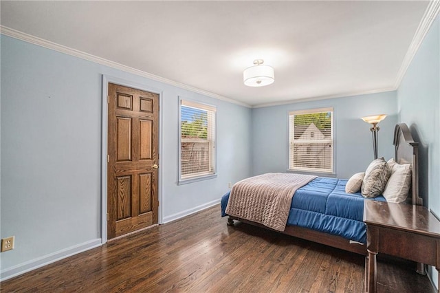bedroom featuring baseboards, wood finished floors, and ornamental molding