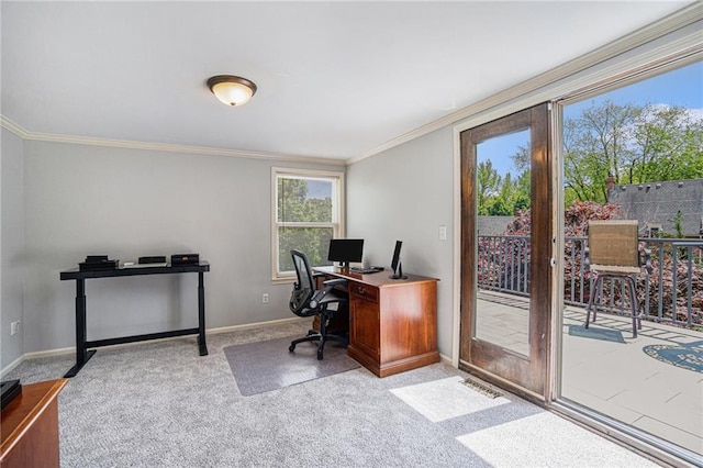 carpeted office space featuring ornamental molding, healthy amount of natural light, and baseboards