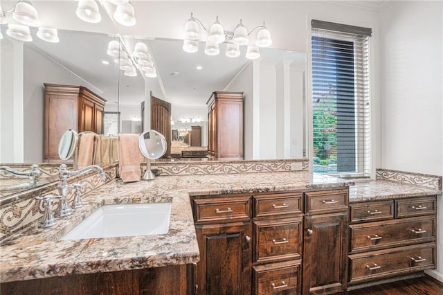 full bath with ornamental molding and double vanity