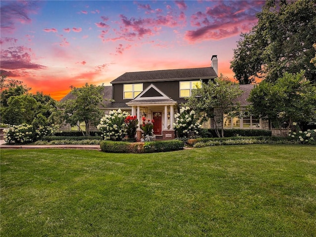 821 W 54th Ter, Kansas City, MO 64112 - view of front facade with a lawn and a chimney