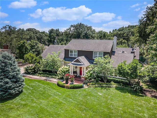 821 W 54th Ter, Kansas City, MO 64112 - view of front of house with a front yard and a chimney