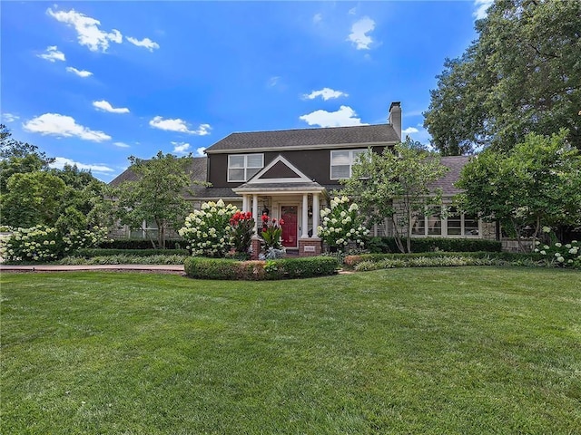 821 W 54th Ter, Kansas City, MO 64112 - view of front of property with a front yard and a chimney