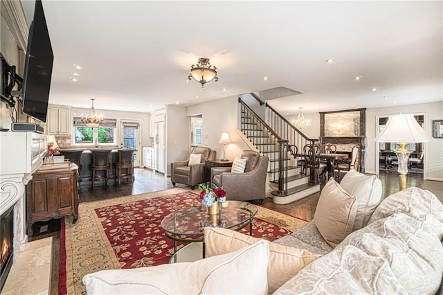 821 W 54th Ter, Kansas City, MO 64112 - living area with a chandelier, a premium fireplace, wood finished floors, stairway, and recessed lighting