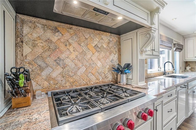 821 W 54th Ter, Kansas City, MO 64112 - kitchen featuring range hood, backsplash, high end stove, light stone countertops, and recessed lighting