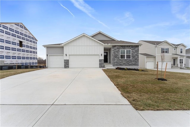 view of front of property featuring a garage and a front lawn