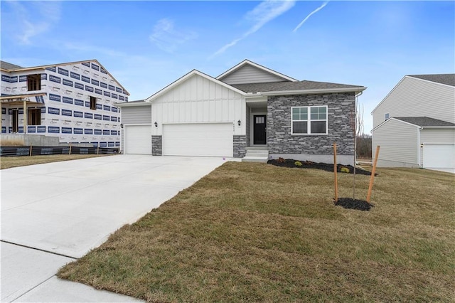 view of front of home with a front yard and a garage