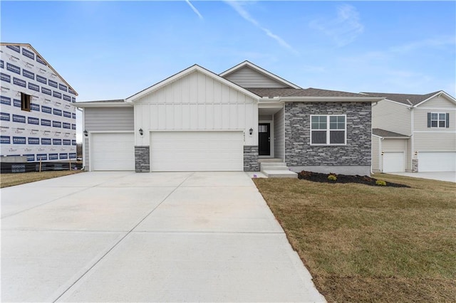 view of front of property with a front yard and a garage