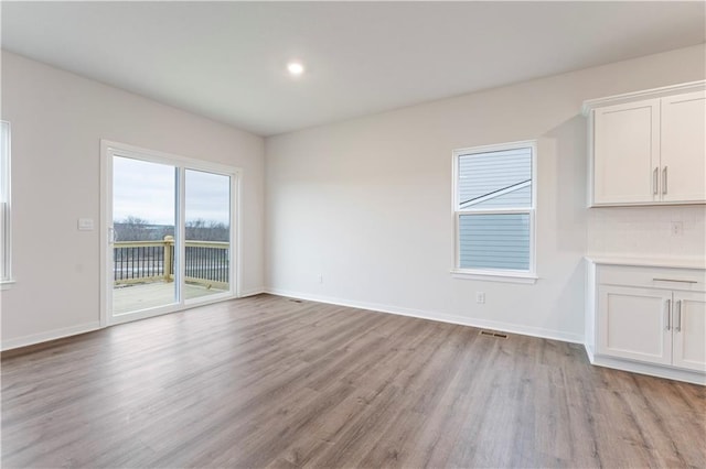 unfurnished dining area featuring light wood-type flooring