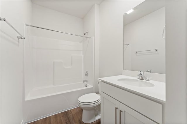 full bathroom with shower / washtub combination, hardwood / wood-style floors, vanity, and toilet