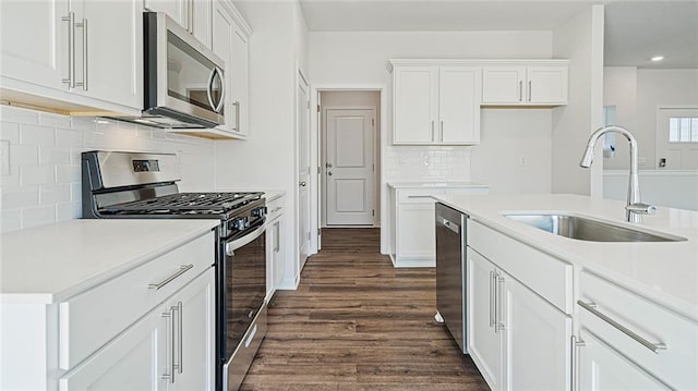 kitchen with sink, white cabinets, dark hardwood / wood-style floors, and appliances with stainless steel finishes