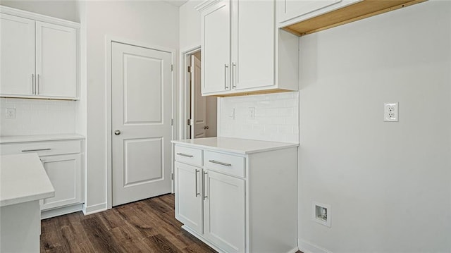 kitchen with white cabinets, decorative backsplash, and dark hardwood / wood-style flooring