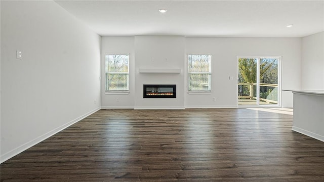 unfurnished living room with dark hardwood / wood-style floors