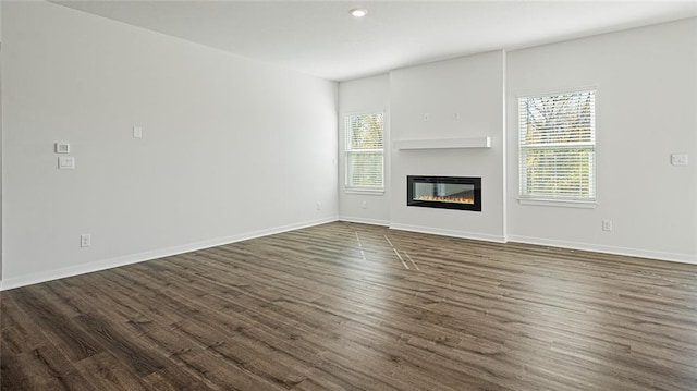 unfurnished living room featuring dark hardwood / wood-style floors