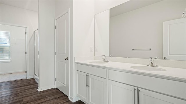 bathroom featuring vanity, an enclosed shower, and hardwood / wood-style flooring