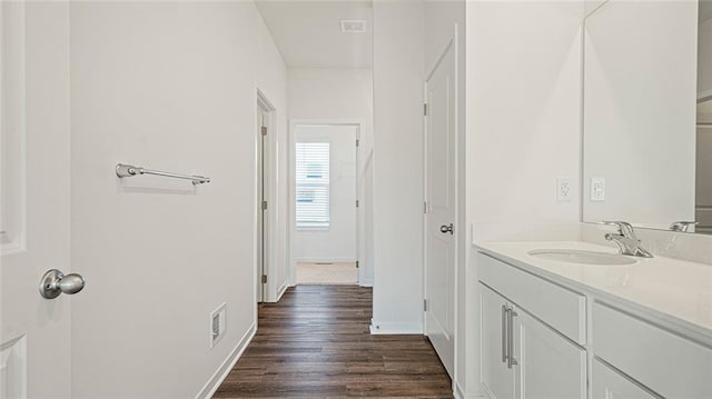 bathroom with hardwood / wood-style floors and vanity