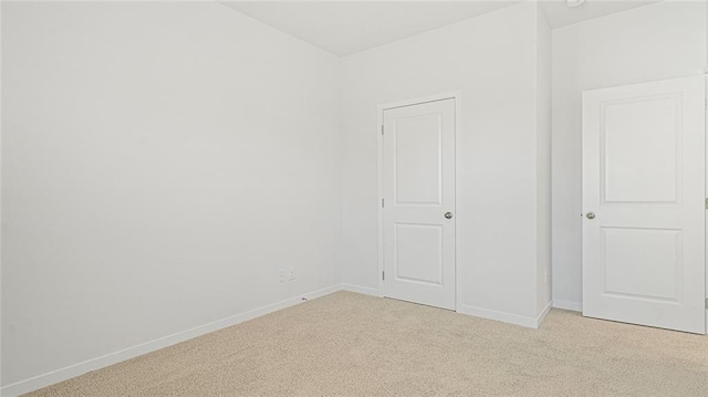 interior space featuring light colored carpet and a closet