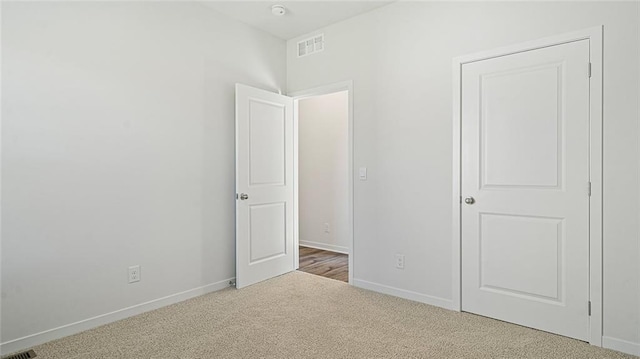 unfurnished bedroom with light colored carpet