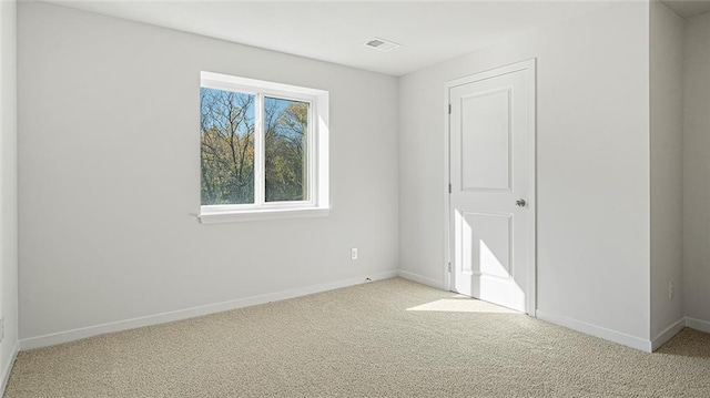 empty room featuring light carpet