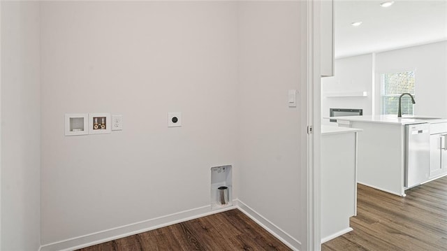 laundry room with hookup for an electric dryer, washer hookup, dark wood-type flooring, and sink