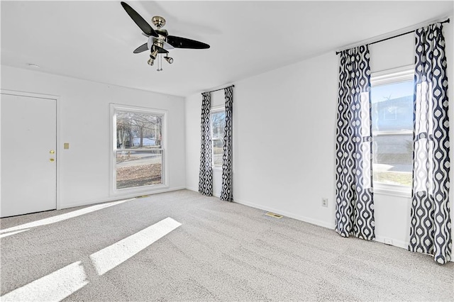 interior space with carpet floors and ceiling fan