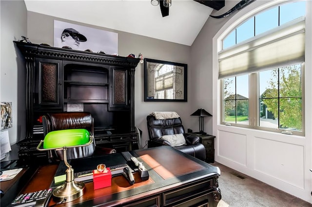 office space with carpet flooring, vaulted ceiling, and ceiling fan