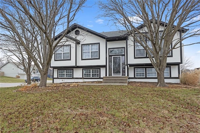 split foyer home with a front lawn