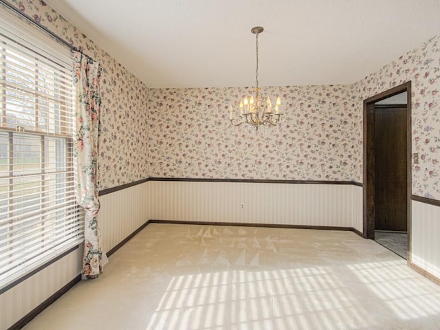 interior space with light colored carpet and an inviting chandelier