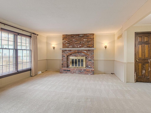 unfurnished living room featuring a fireplace, light carpet, and ornamental molding