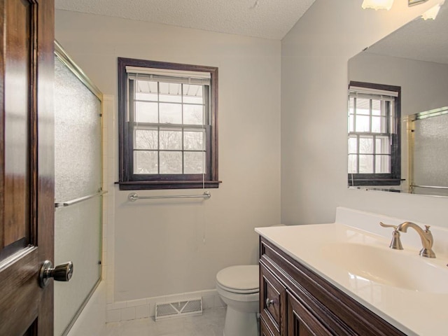 full bathroom with tile patterned floors, vanity, a textured ceiling, shower / bath combination with glass door, and toilet