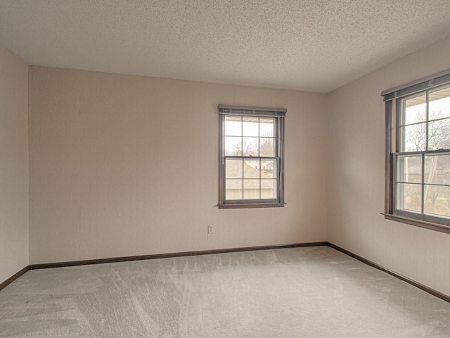 unfurnished room featuring a textured ceiling and carpet floors