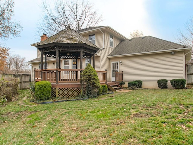 rear view of house featuring a gazebo, a yard, and a wooden deck