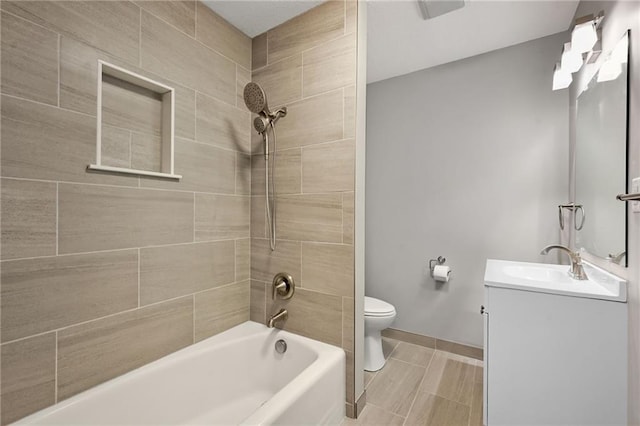 full bathroom with vanity, toilet, and tiled shower / bath combo