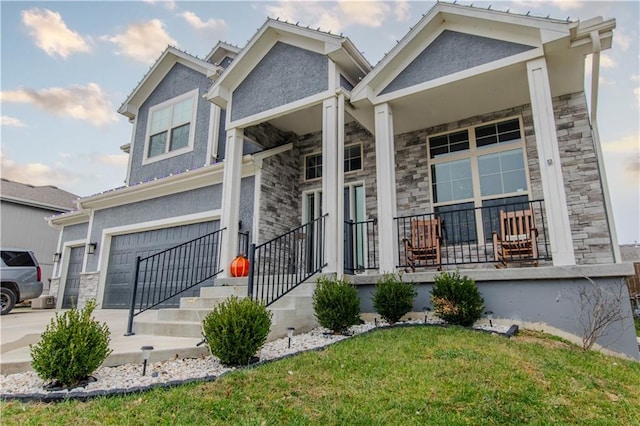 view of front facade featuring a front yard, a porch, and a garage