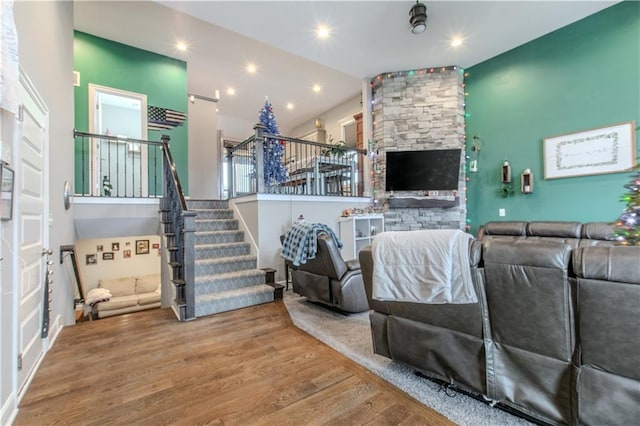 living room featuring hardwood / wood-style floors and vaulted ceiling