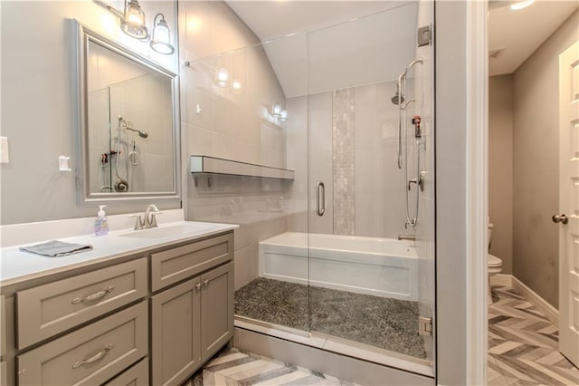 bathroom featuring vanity, toilet, and walk in shower