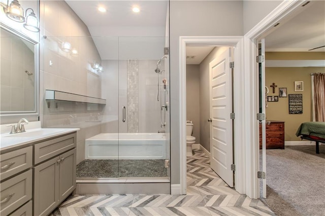 bathroom featuring vanity, an enclosed shower, and toilet