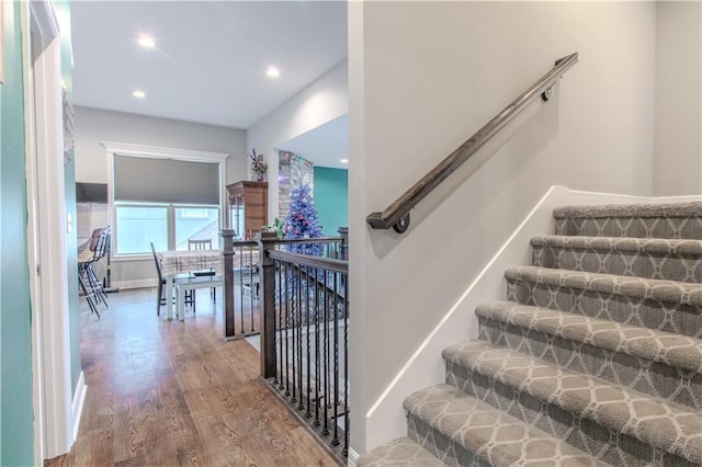 stairs with hardwood / wood-style floors