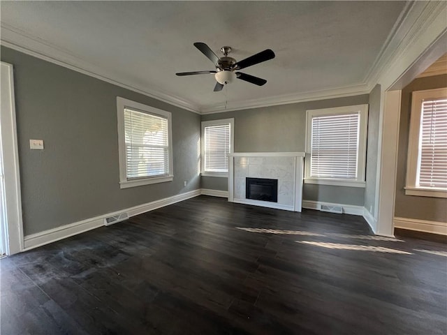 unfurnished living room featuring ceiling fan, dark hardwood / wood-style floors, a premium fireplace, and ornamental molding