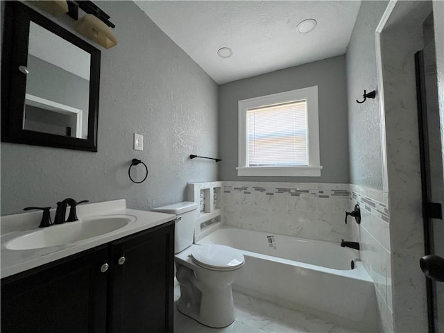 bathroom featuring a tub, vanity, and toilet