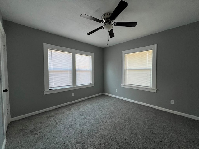 carpeted spare room with ceiling fan and a healthy amount of sunlight