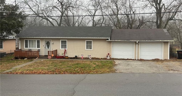 single story home featuring a front yard, a garage, and cooling unit