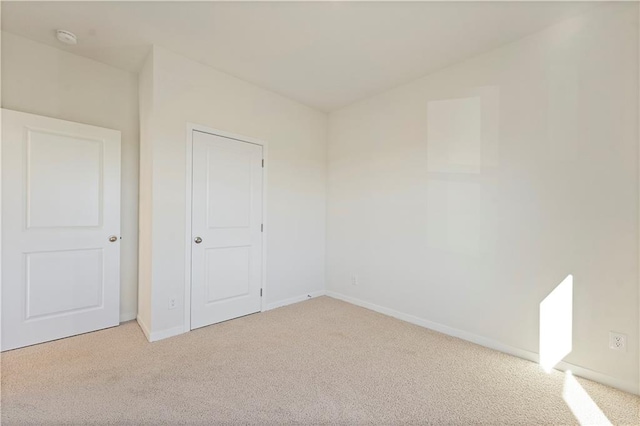 unfurnished bedroom featuring light colored carpet