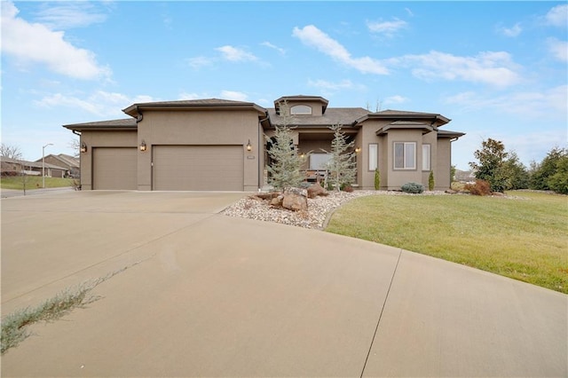 prairie-style home with a garage and a front lawn