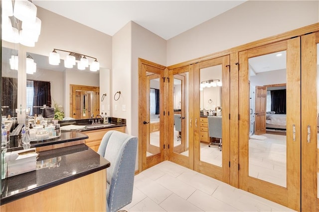 bathroom featuring french doors, vanity, and tile patterned floors