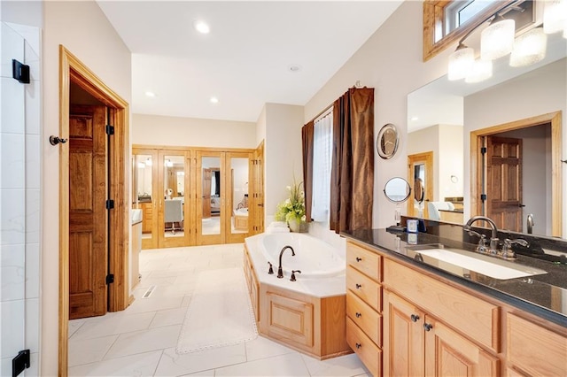 bathroom with vanity and a bath